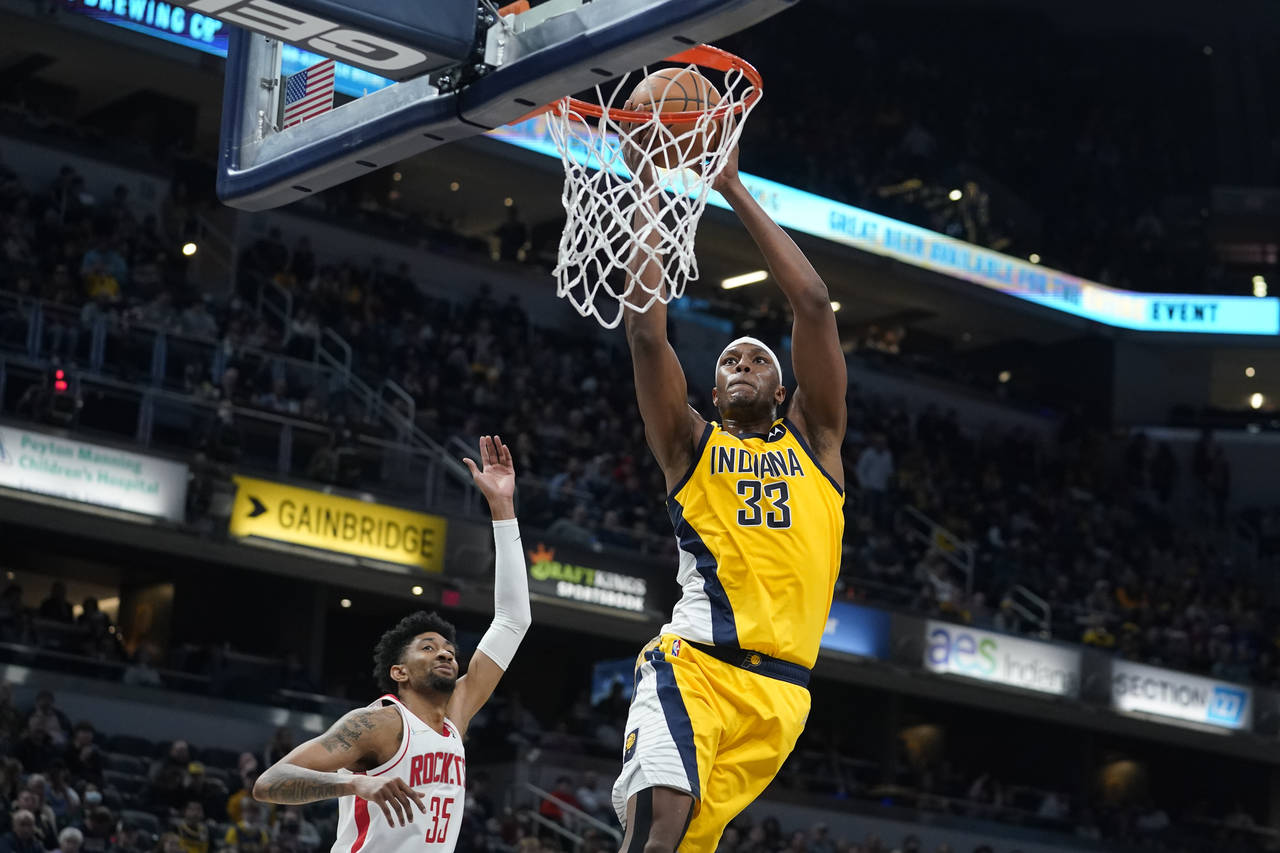 Indiana Pacers' Myles Turner (33) dunks against Houston Rockets' Christian Wood (35) during the sec...