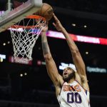 
              Phoenix Suns center JaVale McGee (00) dunks during the second half of an NBA basketball game against the Phoenix Suns in Los Angeles, Monday, Dec. 13, 2021. (AP Photo/Ashley Landis)
            
