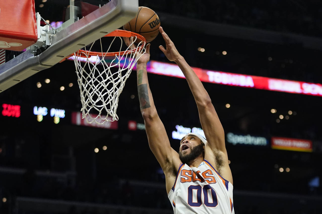 Phoenix Suns center JaVale McGee (00) dunks during the second half of an NBA basketball game agains...
