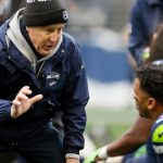SEATTLE, WASHINGTON - JANUARY 02: Head coach Pete Carroll of the Seattle Seahawks talks with Russell Wilson #3 before the game against the Detroit Lions at Lumen Field on January 02, 2022 in Seattle, Washington. (Photo by Steph Chambers/Getty Images)