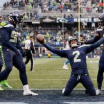 SEATTLE, WASHINGTON - JANUARY 02: D.J. Reed #2 of the Seattle Seahawks celebrates his interception with teammates during the third quarter against the Detroit Lions at Lumen Field on January 02, 2022 in Seattle, Washington. (Photo by Steph Chambers/Getty Images)