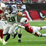 GLENDALE, ARIZONA - JANUARY 09: Rashaad Penny #20 of the Seattle Seahawks runs the ball for a first down during the third quarter against the Arizona Cardinals at State Farm Stadium on January 09, 2022 in Glendale, Arizona. (Photo by Norm Hall/Getty Images)