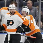 
              Philadelphia Flyers defensemen Keith Yandle (3) and Travis Sanheim (6) look on during a time out in the third period of an NHL hockey game against the New York Islanders, Tuesday, Jan. 25, 2022, in Elmont, N.Y. (AP Photo/Corey Sipkin).
            