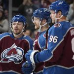 
              Colorado Avalanche left wing Gabriel Landeskog, center, is congratulated after scoring a goal by defenseman Samuel Girard, left, and right wing Mikko Rantanen in the first period of an NHL hockey game against the Buffalo Sabres Sunday, Jan. 30, 2022, in Denver. (AP Photo/David Zalubowski)
            