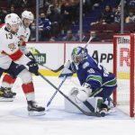 
              Florida Panthers' Sam Reinhart (13) scores against Vancouver Canucks goalie Spencer Martin (30) during the third period of an NHL hockey game Friday, Jan. 21, 2022, in Vancouver, British Columbia. (Darryl Dyck/The Canadian Press via AP)
            