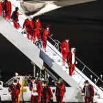
              The Alabama team gets off a plane Friday, Jan. 7, 2022, at Indianapolis International Airport in Indianapolis. Alabama is scheduled to play Georgia on Monday in the College Football Playoff championship game. (Michelle Pemberton/The Indianapolis Star via AP)
            