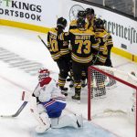 
              Montreal Canadiens goaltender Jake Allen (34) reacts as Boston Bruins players celebrate with Brad Marchand (63) after he scored during the first period of an NHL hockey game, Wednesday, Jan. 12, 2022, in Boston. (AP Photo/Mary Schwalm)
            