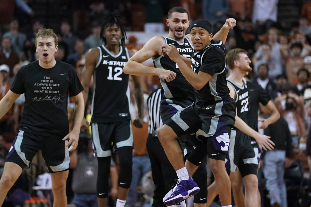 Kansas State players celebrate a win over Texas in an NCAA college basketball game Tuesday, Jan. 18...