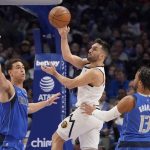
              Denver Nuggets guard Facundo Campazzo, center, passes against Dallas Mavericks center Dwight Powell (7) and Jalen Brunson (13) during the first quarter of an NBA basketball game in Dallas, Monday, Jan. 3, 2022. (AP Photo/LM Otero)
            