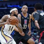 
              New Orleans Pelicans forward Brandon Ingram (14) drives to the basket against Los Angeles Clippers forward Nicolas Batum (33) and forward Marcus Morris Sr. (8) in the first half of an NBA basketball game in New Orleans, Thursday, Jan. 13, 2022. (AP Photo/Gerald Herbert)
            