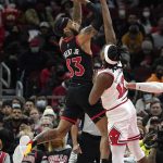 
              Toronto Raptors' Gary Trent Jr. (33) shoots over Chicago Bulls' Ayo Dosunmu during the second half of an NBA basketball game Wednesday, Jan. 26, 2022, in Chicago. The Bulls won 111-105. (AP Photo/Charles Rex Arbogast)
            