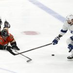
              Anaheim Ducks left wing Max Comtois, left, dives for the puck as Tampa Bay Lightning left wing Alex Killorn reaches for it during the first period of an NHL hockey game Friday, Jan. 21, 2022, in Anaheim, Calif. (AP Photo/Mark J. Terrill)
            