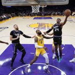 
              Sacramento Kings guard Buddy Hield (24) shoots next to Los Angeles Lakers forward LeBron James (6) during the first half of an NBA basketball game Tuesday, Jan. 4, 2022, in Los Angeles. (AP Photo/Marcio Jose Sanchez)
            