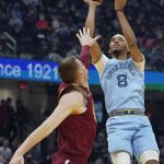 
              Memphis Grizzlies' Ziaire Williams (8) shoots over Cleveland Cavaliers' Dylan Windler (9) in the first half of an NBA basketball game, Tuesday, Jan. 4, 2022, in Cleveland. (AP Photo/Tony Dejak)
            