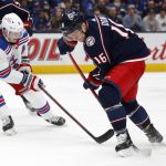 
              Columbus Blue Jackets forward Max Domi, right, reaches for the puck in front of New York Rangers defenseman Jacob Trouba during the second period of an NHL hockey game in Columbus, Ohio, Thursday, Jan. 27, 2022. (AP Photo/Paul Vernon)
            