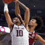 
              Texas A&M forward Ethan Henderson (10) shoots a basket as Arkansas forward Jaylin Williams (10) defends during the second half of an NCAA college basketball game Saturday, Jan. 8, 2022, in College Station, Texas. (AP Photo/Sam Craft)
            