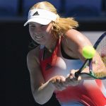 
              Clara Tauson of Denmark plays a backhand return to Anett Kontaveit of Estonia during their second round match at the Australian Open tennis championships in Melbourne, Australia, Thursday, Jan. 20, 2022. (AP Photo/Andy Brownbill)
            
