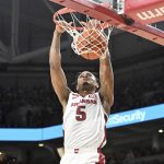 
              Arkansas guard Au'Diese Toney (5) dunks against Texas A&M during the first half of an NCAA college basketball game Saturday, Jan. 22, 2022, in Fayetteville, Ark. (AP Photo/Michael Woods)
            