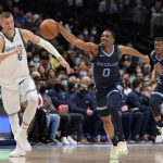 
              Dallas Mavericks center Kristaps Porzingis (6) gives chase as Memphis Grizzlies guard De'Anthony Melton (0) comes away with a steal in the first half of an NBA basketball game in Dallas, Sunday, Jan. 23, 2022. (AP Photo/Tony Gutierrez)
            