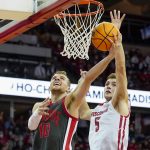 
              Ohio State's Justin Ahrens (10) shoots against Wisconsin's Tyler Wahl (5) during the first half of an NCAA college basketball game Thursday, Jan. 13, 2022, in Madison, Wis. (AP Photo/Andy Manis)
            