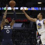 
              Minnesota Timberwolves guard D'Angelo Russell (0) shoots against Golden State Warriors guard Jordan Poole (3) during the first half of an NBA basketball game Sunday Jan. 16, 2022, in Minneapolis. (AP Photo/Stacy Bengs)
            