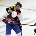 
              The helmet of Boston Bruins left wing Erik Haula (56) goes flying as he fights with Montreal Canadiens center Laurent Dauphin (45) during the third period of an NHL hockey game, Wednesday, Jan. 12, 2022, in Boston. (AP Photo/Mary Schwalm)
            