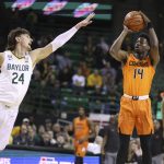
              Oklahoma State guard Bryce Williams, right, shoots over Baylor guard Matthew Mayer, left, in the first half of an NCAA college basketball game, Saturday, Jan. 15, 2022, in Waco, Texas. (Rod Aydelotte/Waco Tribune Herald, via AP)
            