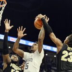 
              Penn State's Greg Lee (5) goes to the basket against Purdue's Trevion Williams (50) and is fouled Purdue's Jaden Ivey (23 during an NCAA college basketball game Saturday, Jan. 8, 2022, in State College, Pa. (AP Photo/Gary M. Baranec)
            