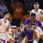 
              LSU forward Darius Days (4) falls as he passes the ball off as he is defended by Tennessee forward Olivier Nkamhoua (13) and forward Uros Plavsic (33) during the first half of an NCAA college basketball game Saturday, Jan. 22, 2022, in Knoxville, Tenn. (AP Photo/Wade Payne)
            