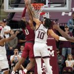 
              Texas A&M forward Ethan Henderson (10) blocks a shot by Arkansas guard Stanley Umude (0) during the second half of an NCAA college basketball game Saturday, Jan. 8, 2022, in College Station, Texas. (AP Photo/Sam Craft)
            
