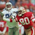 
              FILE - Dallas Cowboys defender Deion Sanders (21) knocks the ball away from San Francisco 49ers receiver Jerry Rice (80) in the second quarter of an NFL football game in Irving, Texas, Nov. 12, 1995. Sunday, Jan. 16, 2022, will be the eighth time these franchises have met in the postseason, tied for the second most of any matchup in the Super Bowl era to the nine games between the Rams and Cowboys. (AP Photo/Eric Gay, File)
            