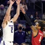
              Northwestern guard Ryan Greer, left, shoots over Maryland guard Fatts Russell during the second overtime of an NCAA college basketball game in Evanston, Ill., Wednesday, Jan. 12, 2022. Maryland won 94-87 in the second overtime. (AP Photo/Nam Y. Huh)
            