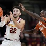 
              Texas guard Andrew Jones, right, tries to steal the ball from Iowa State guard Gabe Kalscheur (22) during the second half of an NCAA college basketball game, Saturday, Jan. 15, 2022, in Ames, Iowa. (AP Photo/Charlie Neibergall)
            