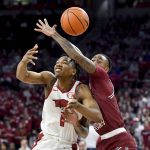 
              South Carolina guard James Reese V, right, knocks the ball away from Arkansas guard JD Notae (1) during the first half of an NCAA college basketball game Tuesday, Jan. 18, 2022, in Fayetteville, Ark. (AP Photo/Michael Woods)
            
