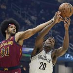 
              Cleveland Cavaliers' Jarrett Allen (31) and Brooklyn Nets' Day'Ron Sharpe (20) battle for a rebound in the first half of an NBA basketball game, Monday, Jan. 17, 2022, in Cleveland. (AP Photo/Tony Dejak)
            