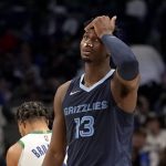 
              Memphis Grizzlies forward Jaren Jackson Jr. (13) wipes his forehead as he walks across the court after a play in the second half of an NBA basketball game against the Dallas Mavericks in Dallas, Sunday, Jan. 23, 2022. Jackson Jr., world gauze in his nostrils for a while after he received a blow to the face off the elbow of the Mavericks' Maxi Kleber. (AP Photo/Tony Gutierrez)
            