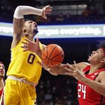 
              Rutgers guard Ron Harper Jr. (24) knocks the ball away from Minnesota guard Payton Willis (0) as Caleb McConnell, far left, watches in the first half of an NCAA college basketball game Saturday, Jan. 22, 2022, in Minneapolis. (AP Photo/Bruce Kluckhohn)
            
