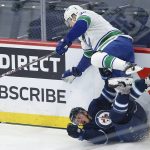 
              Vancouver Canucks' Alex Chiasson (39) jumps over Winnipeg Jets' Nate Schmidt (88) during first-period NHL hockey game action in Winnipeg, Manitoba, Thursday, Jan. 27, 2022. (John Woods/The Canadian Press via AP)
            