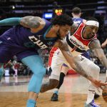 
              Washington Wizards guard Kentavious Caldwell-Pope (1) and Charlotte Hornets forward Miles Bridges (0) battle for the ball during the first half of an NBA basketball game, Monday, Jan. 3, 2022, in Washington. (AP Photo/Nick Wass)
            