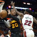 
              Atlanta Hawks forward John Collins (20) looks to pass as Miami Heat forward Jimmy Butler (22) defends during the first half of an NBA basketball game, Friday, Jan. 14, 2022, in Miami. (AP Photo/Lynne Sladky)
            