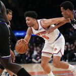 
              New York Knicks' Quentin Grimes drives through Sacramento Kings' defenders during the second half of the NBA basketball game, Monday, Jan. 31, 2022, in New York. The Knicks defeated the Kings 116-96. (AP Photo/Seth Wenig)
            