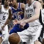 
              San Antonio Spurs' Jakob Poeltl (25) and Philadelphia 76ers' Charlie Brown Jr. (16) fight for the rebound during the first half of an NBA basketball game, Sunday, Jan. 23, 2022, in San Antonio. (AP Photo/Darren Abate)
            
