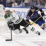 
              Dallas Stars defenseman Andrej Sekera (5) falls to the ice as St. Louis Blues center Oskar Sundqvist (70) looks for control of the puck during the second period of an NHL hockey game Sunday, Jan. 9, 2022, in St. Louis. (AP Photo/Joe Puetz)
            