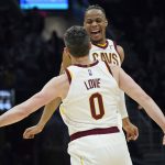 
              Cleveland Cavaliers' Isaac Okoro, right, and Kevin Love celebrate in the second half of an NBA basketball game against the New York Knicks, Monday, Jan. 24, 2022, in Cleveland. (AP Photo/Tony Dejak)
            