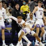 
              Washington players on the bench react to a score by their team against California late in the second half of an NCAA college basketball game Wednesday, Jan. 12, 2022, in Seattle. Washington won 64-55. (AP Photo/Elaine Thompson)
            