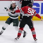 
              Minnesota Wild center Connor Dewar, left, and Chicago Blackhawks right wing MacKenzie Entwistle fight during the first period of an NHL hockey game in Chicago, Friday, Jan. 21, 2022. (AP Photo/Nam Y. Huh)
            