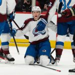 
              On his knees, Colorado Avalanche's Nathan MacKinnon (29) celebrates his goal against the Arizona Coyotes during the first period of an NHL hockey game Saturday, Jan. 15, 2022, in Glendale, Ariz. (AP Photo/Darryl Webb)
            