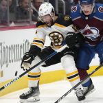 
              Colorado Avalanche defenseman Cale Makar, right, checks Boston Bruins center Craig Smith as he tries to control the puck in the second period of an NHL hockey game Wednesday, Jan. 26, 2022, in Denver. (AP Photo/David Zalubowski)
            