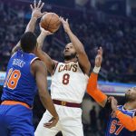 
              Cleveland Cavaliers' Lamar Stevens (8) shoots between New York Knicks' Alec Burks (18) and Taj Gibson (67) in the first half of an NBA basketball game, Monday, Jan. 24, 2022, in Cleveland. (AP Photo/Tony Dejak)
            