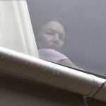 
              A person believed to be Renata Voracova, a tennis player from the Czech Republic, looks out of a window at the Park hotel immigration detention centre in Melbourne, Australia, Saturday, Jan. 8, 2022. Voracova, who has already played in a warm-up tournament in Melbourne, was being detained in the same immigration hotel as Serbian tennis star Novak Djokovic but is believed to be leaving the country later today. (James Ross/AAP Image via AP)
            